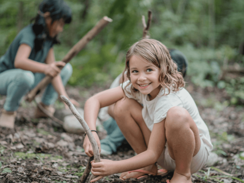 mädchen sitzt im wald und schnitzt schnitzen mit kindern